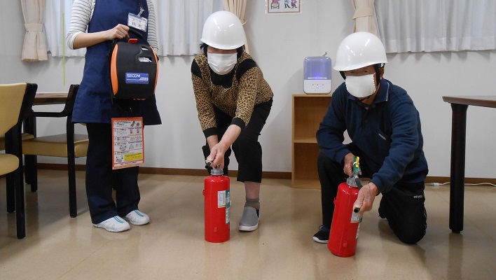 消火器を持つご利用者さま